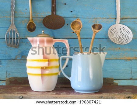 vintage kitchen utensils plus a cacao can and a milk mug