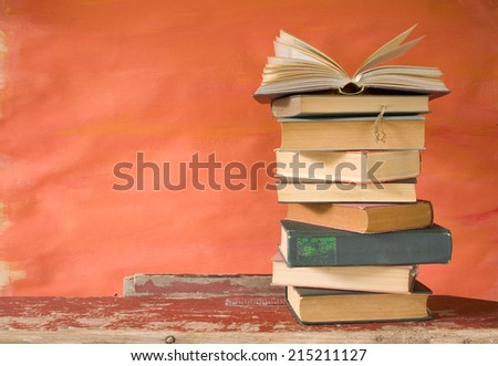 stack of books, one open, grungy background,free copy space