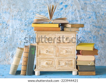 stacks of books and a small chest of drawers, free copy space