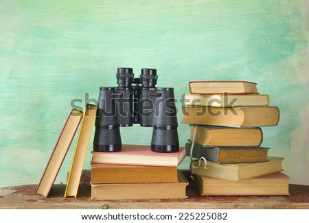 books with binoculars, search, research, education concept, free copy space