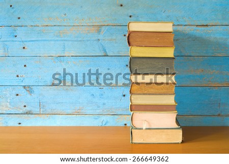 stack of books on a wooden shelf, free copy space