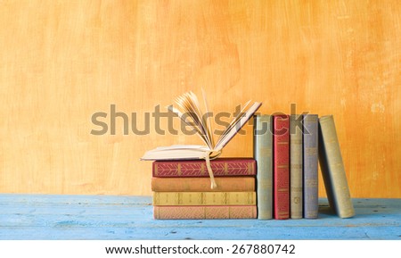 stack of books, one opened, free copy space