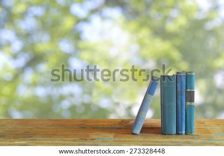 row of books, nature background, free copy space
