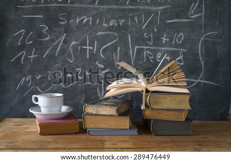 books, cup of coffee, black board, education,learning,science concept