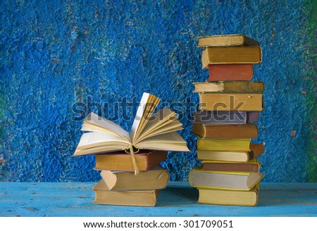stack of books, one opened, grungy background,free copy space