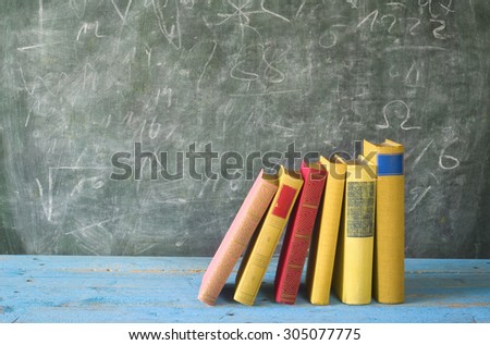 row of books blackboard, education,learning,science concept
