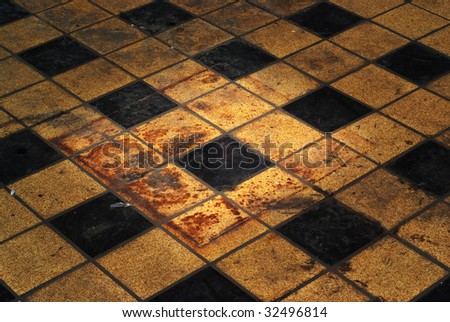 Grungy vintage retro floor with tiles, traces of rust