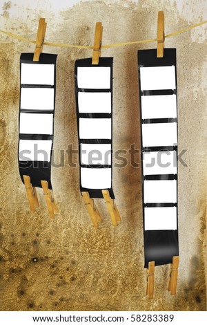 blank film strips, against grungy background, empty frames, free picture or copy space