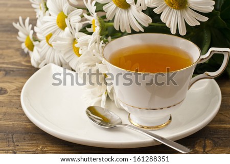 Cup of herbal tea with chamomile flowers