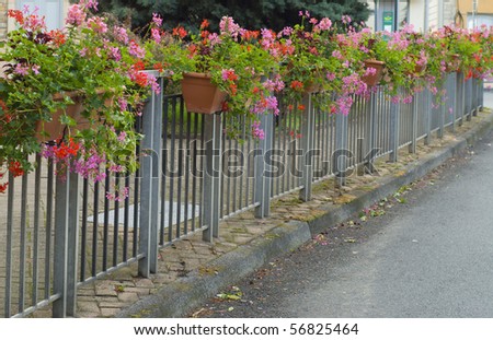 Street fence decorated with flowers