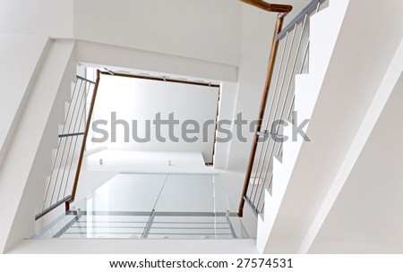 Bright staircase with wooden handhold in public space
