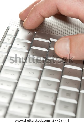 Man finger above the laptop delete key