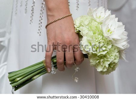 Bride hold bouquet with white natural flowers