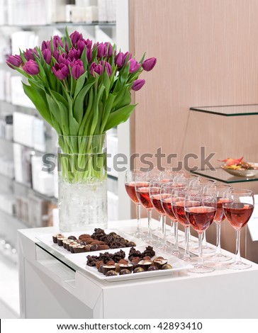 Chocolate candy set, glasses of rose wine, bouquet of tulips