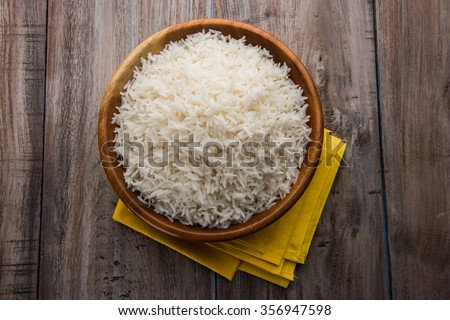 indian basmati rice, pakistani basmati rice, asian basmati rice, cooked basmati rice, cooked white rice, cooked plain rice in wooden bowl over brown wooden background