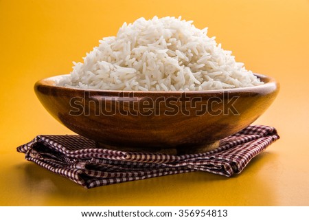 indian basmati rice, pakistani basmati rice, asian basmati rice, cooked basmati rice, cooked white rice, cooked plain rice in wooden bowl over yellow background