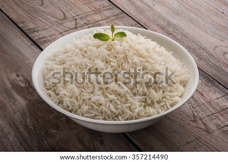 basmati rice in a brass bowl, cooked basmati rice, cooked plain rice, cooked white basmati rice, steamed basmati rice served in white bowl over wooden background
