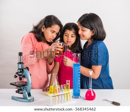 indian little girls or indian students and science experiments. Education. asian kids and science experiments, chemistry experiment, indian girls and science experiments