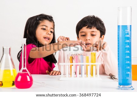 4 year old indian boy and girl doing science experiment, science Education. asian kids and science experiments, chemistry experiment, indian kids and science experiments, indian kids and science lab