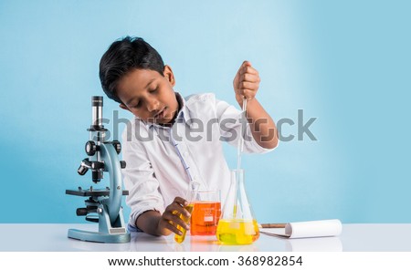 indian boy and chemistry experiment and microscope, asian boy with microscope and doing chemistry experiment, indian boy and science experiment