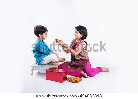 Pooja ceremony performed by cute looking sister and small brother on rakhi festival in India