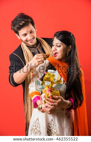 indian brother and sister enjoying and celebrating Raksha Bandhan festival