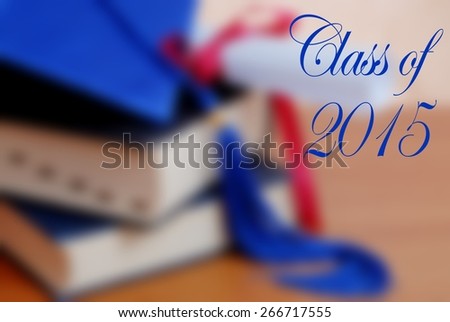 Class of 2015 message over background blur of graduation themed items including books, blue cap and tassel, and diploma tied with red ribbon. Horizontal composition. Blue text is fancy cursive style