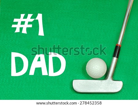 Golf clubs and golf ball on green felt background. Happy Father\'s Day message in white on the green felt.