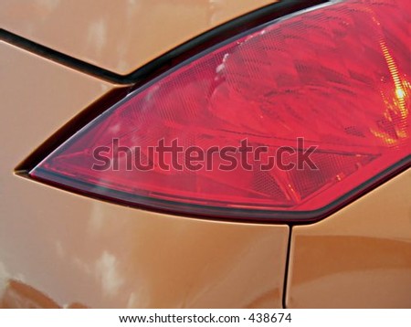 Detail of red brake light on new sports car making for interesting combination of color and lines