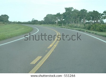 Two lane highway curved to left in rural area