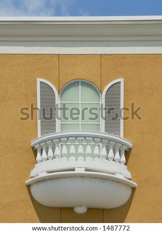 Arched window with shutters and balcony