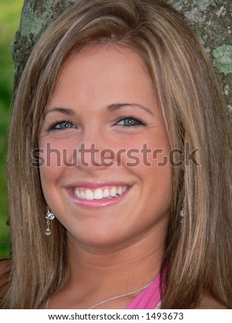 headshot of attractive teenage girl with big smile