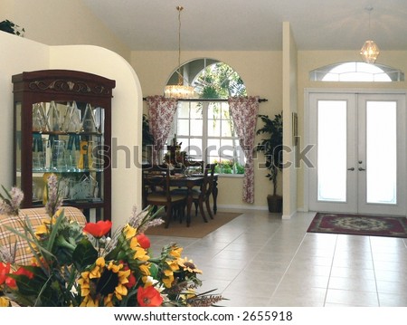 Entry and dining area of contemporary home shot from living area in foreground
