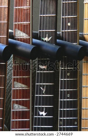 Detail of electric guitar necks in a guitar stand