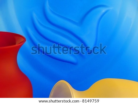 Three frosted glass vases in primary colors as abstract or background