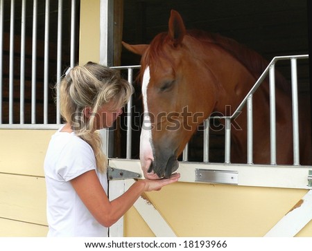 Woman and horse in gentle, trusting relationship