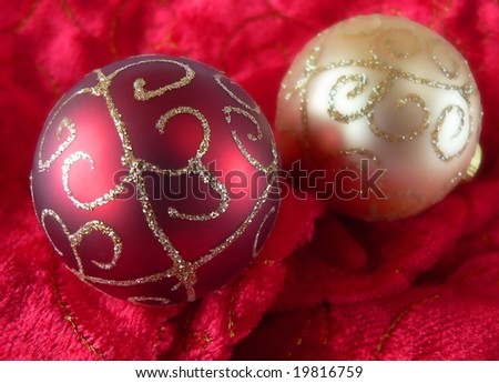 gold and red christmas ornaments on soft red and gold fabric