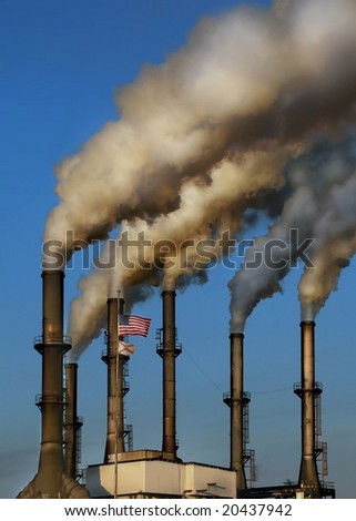 HDR image of working factory smokestacks in late afternoon sun