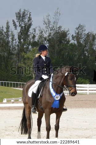 Blue Ribbon winning rider at dressage event waiting for award ceremony