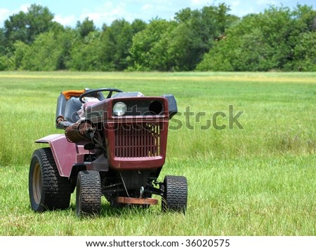 industrial agricultural scene of abandoned old rusted and dusty tractor in an empty field