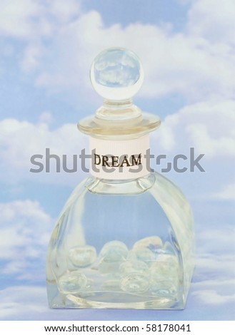 clear bottle with beads on cloudy sky background concept of bottled hopes, dreams, wishes