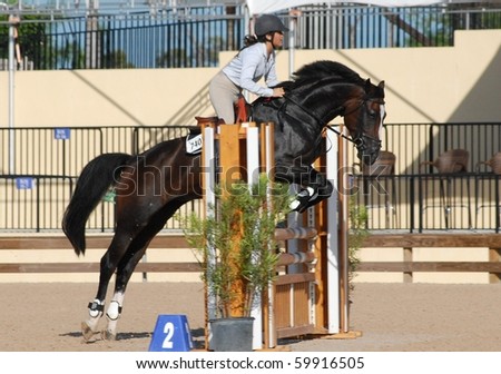WELLINGTON, FLORIDA - AUG 28: An unidentified competitor clears a jump at the first Equestrian Sport Productions\' Show of the 2010-2011 season on August 28, 2010 in Wellington, Florida.