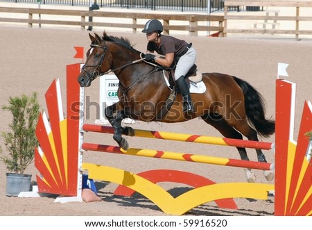 WELLINGTON, FLORIDA - AUG 28: An unidentified competitor clears a jump at the first Equestrian Sport Productions\' Show of the 2010-2011 season on August 28, 2010 in Wellington, Florida.