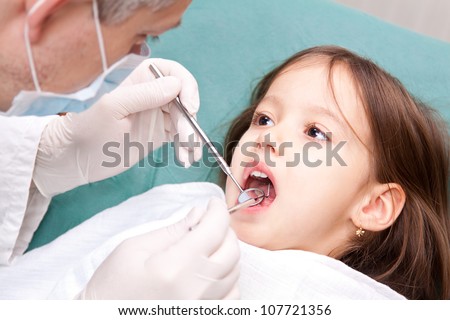 at the dentist - little girl have a consultation - stock-photo-at-the-dentist-little-girl-have-a-consultation-107721356