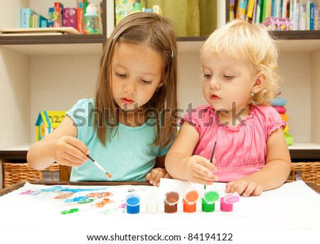 sisters drawing with colored paint