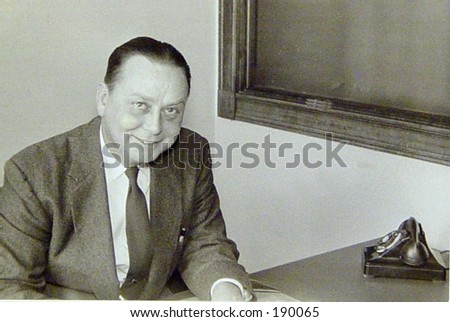 1950\'s business man at new desk.  Vintage black and white.