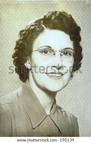 Portrait of woman in late thirties or early forties. Wearing glasses and simple makeup.