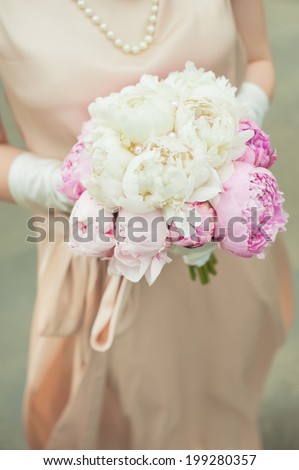bouquet in the hands of the bride. peonies