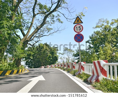 Mountain road bending, warning sign and speed limit