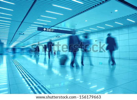 clean tiled floor, blurred view of people walking